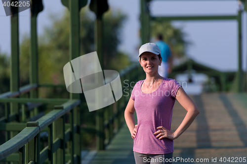 Image of woman  stretching before morning jogging