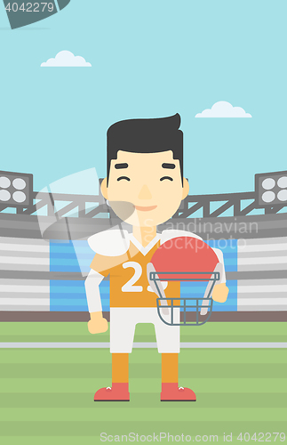 Image of Rugby player with ball and helmet in hands.