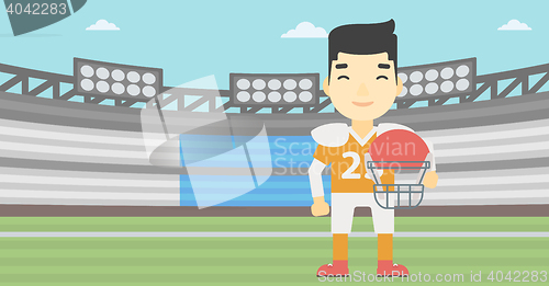 Image of Rugby player with ball and helmet in hands.