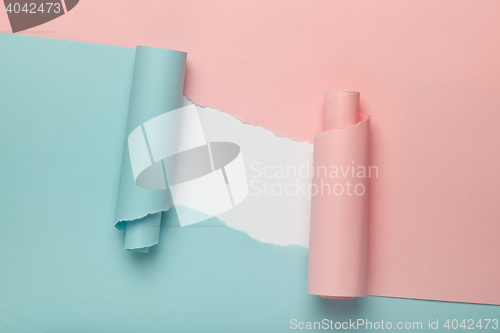 Image of Torn blue and pink colored paper