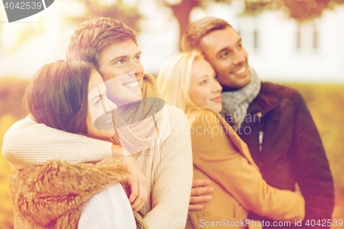 Image of group of friends having fun in autumn park