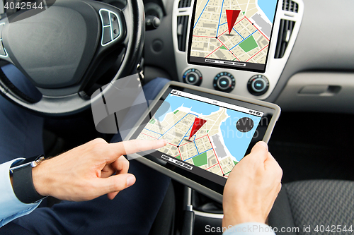 Image of close up of man with tablet pc in car