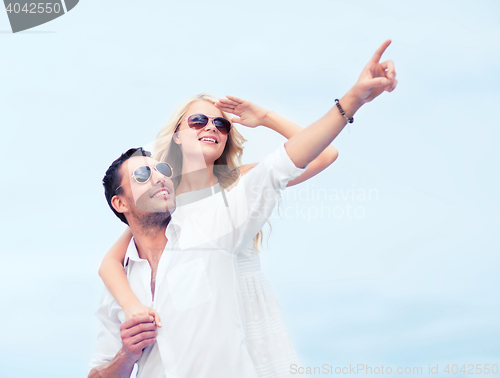 Image of couple in shades at sea side