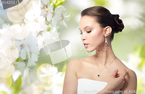 Image of beautiful asian woman with earring and pendant