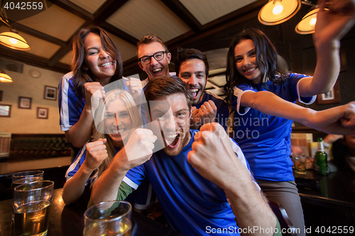 Image of football fans or friends with beer at sport bar