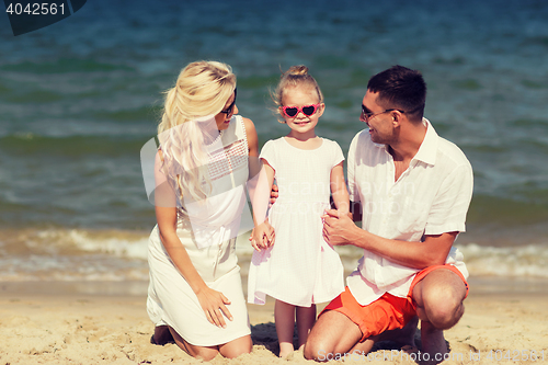 Image of happy family in sunglasses on summer beach