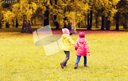 Image of happy little girls running outdoors