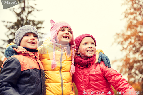 Image of group of happy children hugging in autumn park