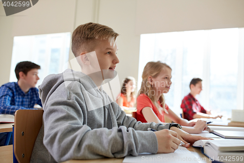 Image of group of students with books at school lesson