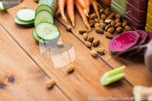 Image of different vegetables and almond nuts on wood