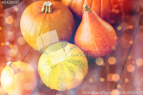 Image of close up of pumpkins on wooden table at home