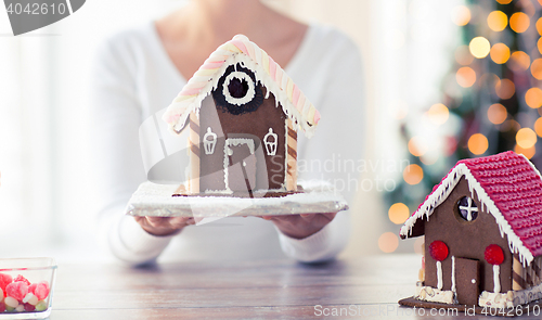 Image of close up of woman showing gingerbread house