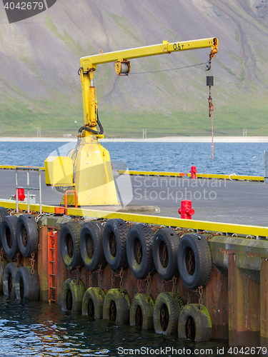 Image of Fishing crane in small seaside Iceland town harbor