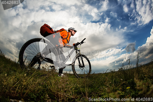 Image of Young man travel by bicycle on rural road