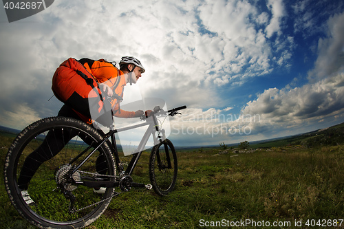 Image of Young man travel by bicycle on rural road