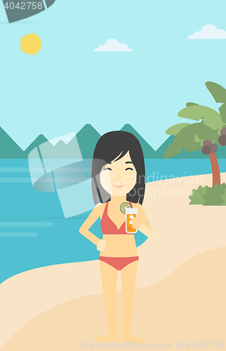 Image of Woman with cocktail on the beach.