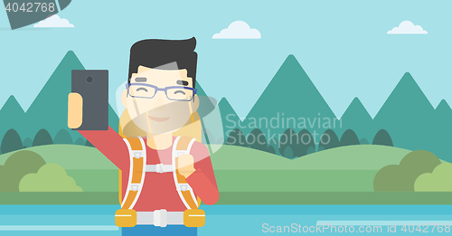 Image of Man with backpack making selfie.