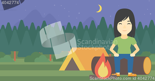 Image of Woman sitting on log in the camping.