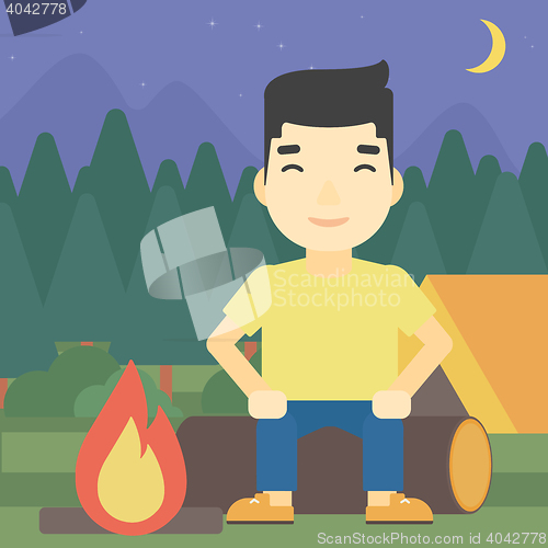Image of Man sitting on log in the camping.