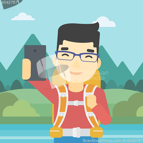 Image of Man with backpack making selfie.