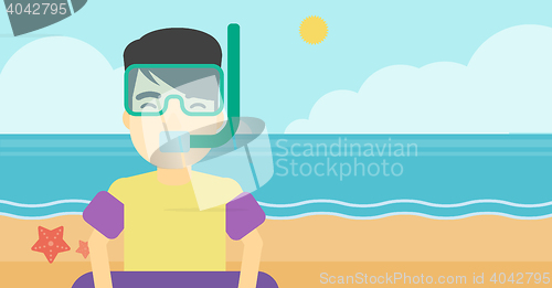 Image of Man with snorkeling equipment on the beach.