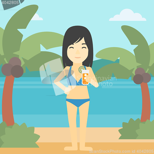 Image of Woman with cocktail on the beach.