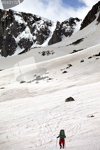 Image of Hiker in snowy mountain at nice spring day