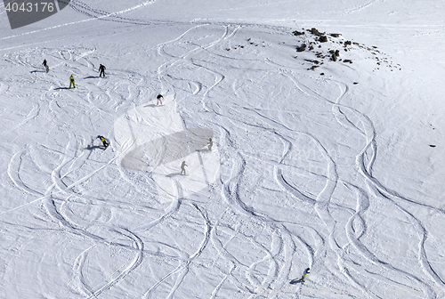 Image of Snowboarder downhill on off piste slope with newly-fallen snow