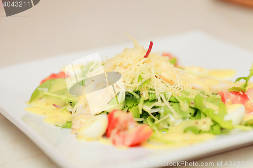 Image of salad with eggs, tomatoes, chicken and cheese