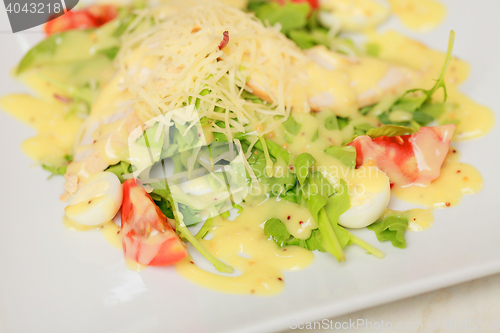 Image of salad with eggs, tomatoes, chicken and cheese