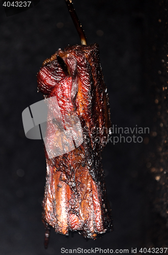 Image of Smoking pork neck in home smokehouse