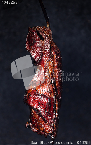 Image of Smoking pork neck in home smokehouse