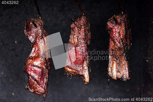Image of Smoking pork neck in home smokehouse