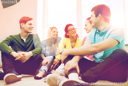 Image of five smiling teenagers having fun at home