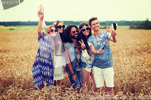 Image of hippie friends with smartphone on selfie stick