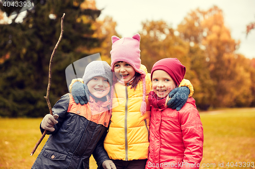 Image of group of happy children hugging in autumn park