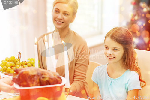 Image of smiling family having holiday dinner at home