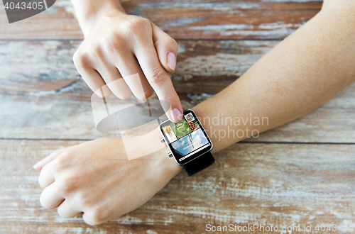 Image of close up of female hands with news on smart watch