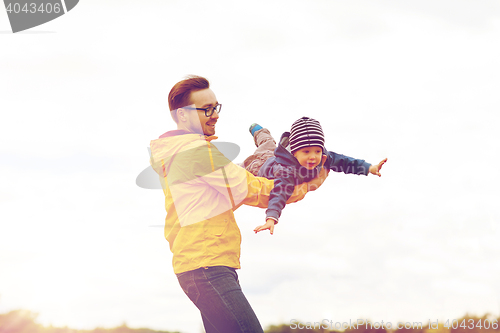 Image of father with son playing and having fun outdoors