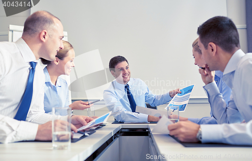 Image of group of smiling businesspeople meeting in office