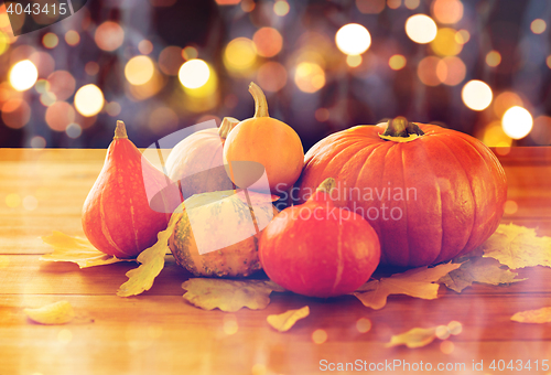 Image of close up of halloween pumpkins on wooden table