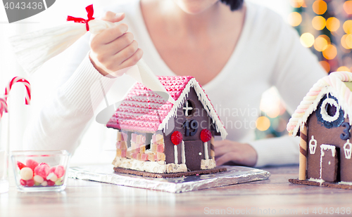 Image of close up of woman making gingerbread houses