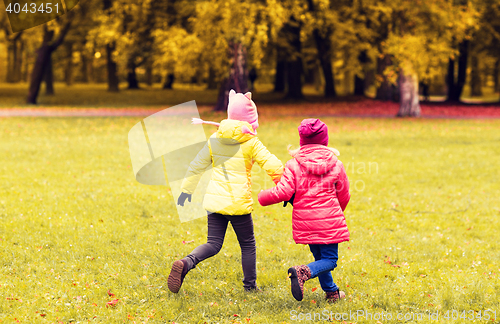 Image of happy little girls running outdoors