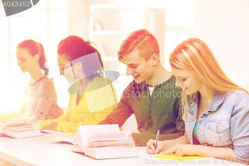 Image of students with textbooks and books at school