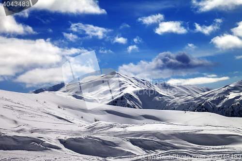 Image of Ski slope and beautiful sky with clouds in sun evening