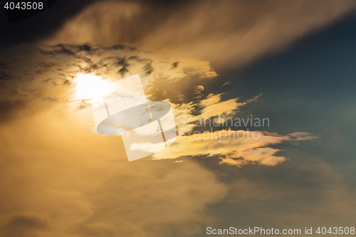 Image of sunset with sun clouds over clouds