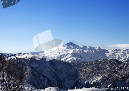 Image of View on snowy mountains and blue sky in sunny morning