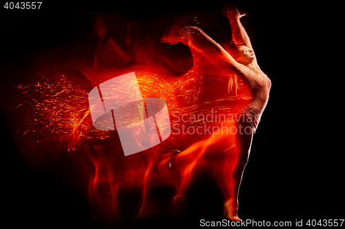 Image of Fine art portrait of beautiful woman dancer in red sparkles