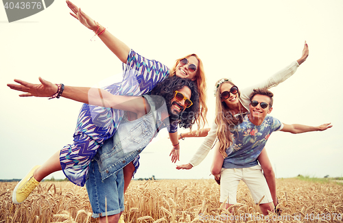 Image of happy hippie friends having fun on cereal field