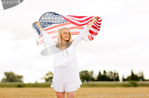 Image of happy woman with american flag on cereal field